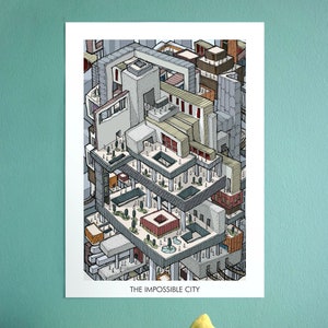 May include: A print of "The Impossible City" shows a detailed, isometric illustration of a multi-level urban landscape. The artwork uses grey, beige, and red tones, with numerous buildings and figures. The title is displayed at the bottom.
