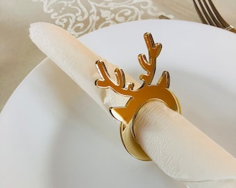 May include: Gold reindeer napkin ring. The reindeer is made of mirrored acrylic and has a ring for holding a napkin.