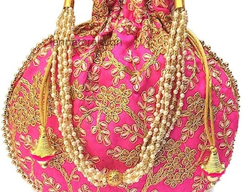 May include: A pink drawstring bag with gold embroidery and pearl accents. The bag has a round shape and a tassel.