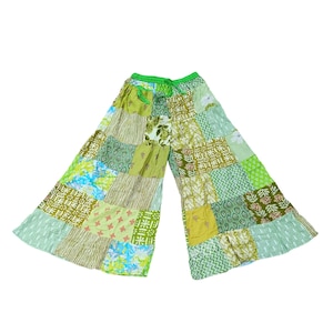 May include: Wide-leg patchwork pants in shades of green, yellow, and blue. The pants feature a drawstring waist and a variety of patterned fabric squares. The overall design is bohemian and casual.