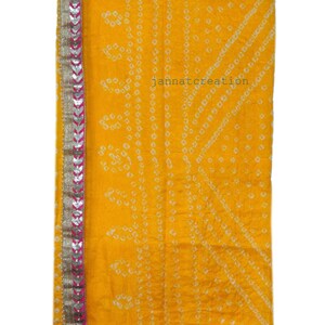 May include: A bright yellow textile with a geometric pattern and a decorative border. The border features silver and pink accents. The text "jannatcreation" is visible on the fabric.