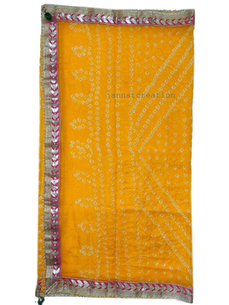 May include: A bright yellow textile with a geometric pattern and a decorative border. The border features silver and pink accents. The text "jannatcreation" is visible on the fabric.