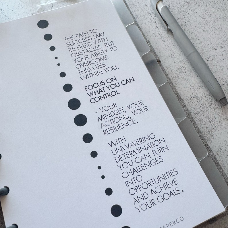 May include: A motivational quote about focusing on what you can control in life. The quote is written in black text on a white background with a series of black dots down the left side of the page.