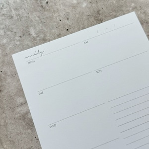 May include: A weekly planner with a simple design. The planner has a white background with black lines and text. The days of the week are listed at the top of each column: Mon, Tue, Wed, Thu, Fri, Sat, Sun.