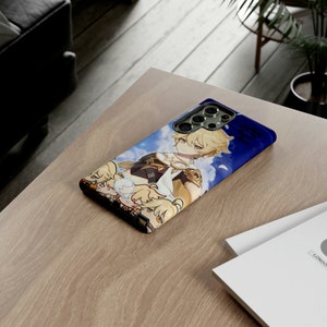 May include: A blue phone case with a white and blue anime character design. The character has blonde hair and is wearing a white and gold outfit. The phone case has a camera lens cutout and a blue background.