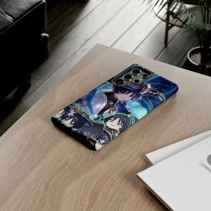 May include: A phone case with a blue and green design featuring a cartoon character with a hat and other characters. The case has a camera cutout and a black border.
