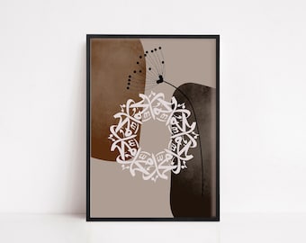 May include: A framed wall art print featuring a circular arrangement of white Arabic calligraphy centred over abstract brown and beige shapes. A thin black line drawing of a dandelion seed head extends upwards from the calligraphy.
