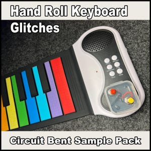May include: A flexible hand roll keyboard with a white control panel featuring a speaker, six white buttons labeled Demo, Record, E/Sustain, Play, Tone, and Stop, and a clear plastic housing containing one red and one yellow button.