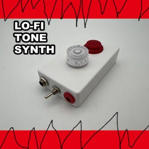 May include: A white rectangular electronic device labeled LO-FI TONE SYNTH featuring a clear rotary knob with numbered markings, a red circular push button, a metal toggle switch, and two circular input ports on the side of the casing.