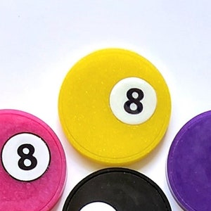 May include: Ten round plastic chips with the number 8 printed on them. The chips are in different colors: yellow, pink, purple, black, green, pink, blue, and orange.