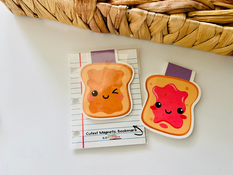 May include: Two magnetic bookmarks shaped like slices of toast. One slice has peanut butter and the other has strawberry jam. Both have cute cartoon faces.