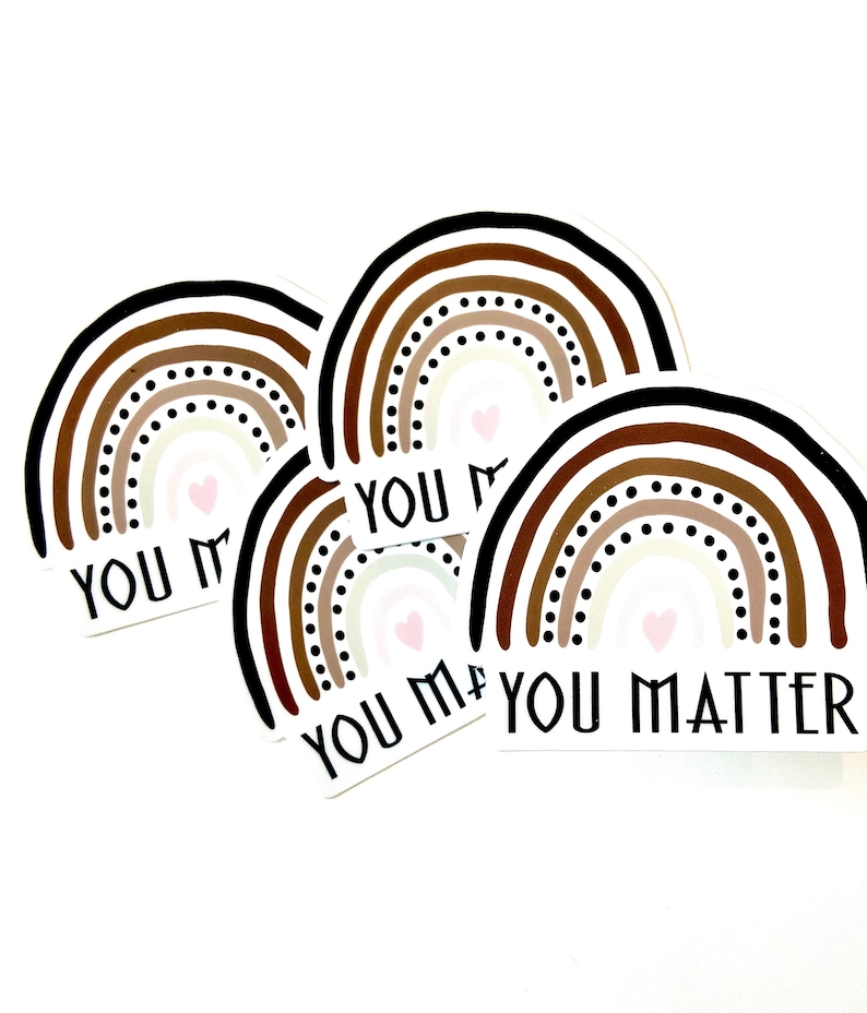 May include: Four rainbow stickers with the text "You Matter" in black lettering. The rainbows are made up of brown, beige, and white stripes with black dots. Each rainbow has a small pink heart in the center.