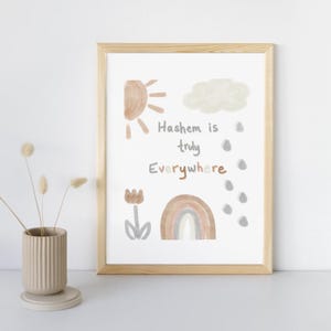 May include: A framed print with a watercolor illustration of a sun, a cloud, a rainbow, a flower, and raindrops. The text reads "Hashem is truly Everywhere".