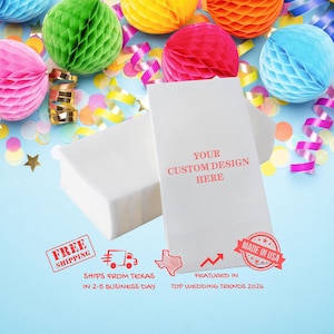 May include: Two white rectangular gift boxes and a white gift bag with the text "YOUR CUSTOM DESIGN HERE" on a light blue background. The background is decorated with colourful honeycomb paper balls, confetti, and ribbons.
