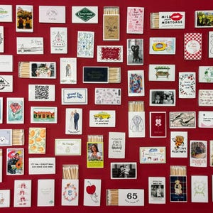a red wall covered in lots of different types of cards