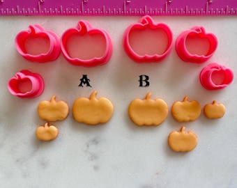 May include: A set of pink pumpkin-shaped cookie cutters and gold fondant pumpkins of various sizes. The cutters are labeled A and B.