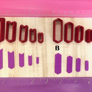 May include: Two sets of red and purple plastic cookie cutters. The red set is labeled "A" and features five different sizes of a pointed arch shape. The purple set is labeled "B" and features five different sizes of a hexagonal shape.
