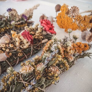 May include: Three bundles of dried herbs and flowers tied together with twine. The bundles are made with a variety of dried flowers and herbs, including lavender, rosemary, and chamomile. The bundles are a natural and fragrant way to add a touch of nature to your home.