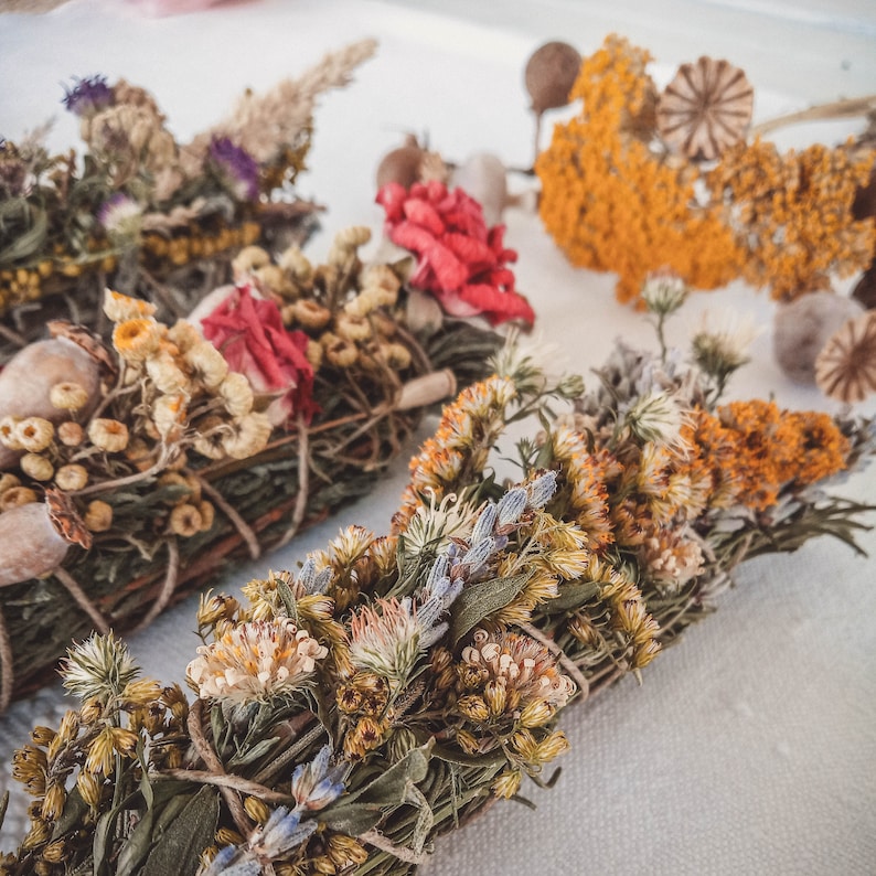May include: Three bundles of dried herbs and flowers tied together with twine. The bundles are made with a variety of dried flowers and herbs, including lavender, rosemary, and chamomile. The bundles are a natural and fragrant way to add a touch of nature to your home.