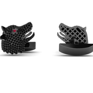May include: A pair of cufflinks shaped like wolf heads, featuring a black finish covered in small black stones and a single red stone for the eye. The back of the wolf head design shows a grid-like metal structure with a black bar closure mechanism.