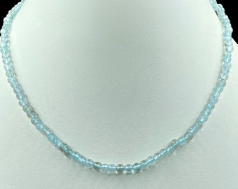 May include: A light blue aquamarine gemstone necklace with round beads.