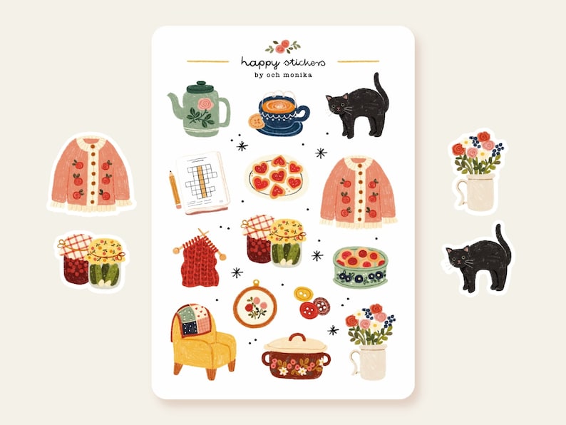 Op de afbeelding: Een vel stickers met illustraties van een theepot, een kopje thee, een kat, een trui, een pot jam, een kom met fruit, een stoel, een pan en bloemen. De stickers zijn ontworpen in een speelse stijl met felle kleuren en patronen. De tekst "happy stickers by ooh monika" staat bovenaan het vel gedrukt.