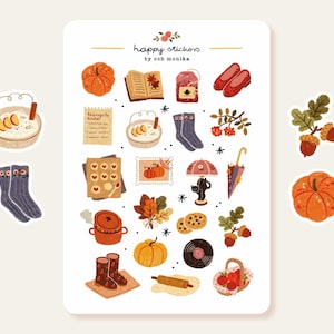 Op de afbeelding: Een vel herfststickers met illustraties van pompoenen, eikels, sokken en andere herfstachtige elementen. De tekst "happy stickers by och monika" staat bovenaan. De stickers zijn in verschillende kleuren, waaronder oranje, bruin en rood.