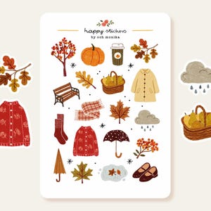 Pode incluir: Uma folha de autocolantes intitulada happy stickers by och monika com ilustrações de outono, incluindo uma abóbora, um cesto de peras, um casaco bege, um cardigã vermelho, um banco de jardim, um cachecol, folhas e nuvens de chuva.