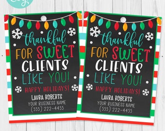 May include: Two holiday-themed gift tags with a black background and colorful text. The tags read "thankful FOR SWEET CLIENTS LIKE YOU! HAPPY HOLIDAYS!" with a business name and phone number. The borders are red, green, and white.