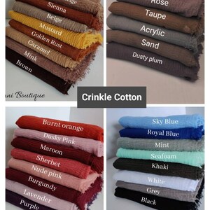 May include: A stack of 10 different colored crinkle cotton scarves. The colors are: golden beige, sienna, beige, mustard, golden rust, caramel, mink, brown, rose, taupe, acrylic, sand, dusty plum, burnt orange, dusky pink, maroon, sherbet, nude pink, burgundy, lavender, purple, sky blue, royal blue, mint, seafoam, khaki, white, grey, and black.