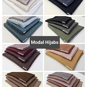 May include: A collection of 20 modal hijab scarves in various colors, including earth, beige, lush cream, teal, grey, pale mint, teal green, mauve, maroon, dusky plum, brown, cappuccino, mocha, chestnut, hazel, light blue, denim, navy, black, charcoal, dark grey, forest, terracotta, blush, honeydew, shadow, tan, dusky rose, and cashmere.