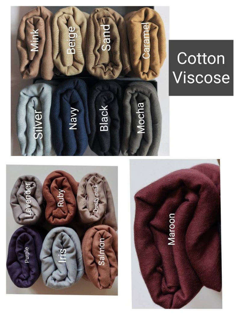 May include: Assortment of rolled fabric swatches in various colors, including purple, lavender, silver, mink, iris, ruby, navy, beige, dusty pink, salmon, black, sand, mocha, caramel, and maroon. The fabric is labeled "Cotton Viscose".