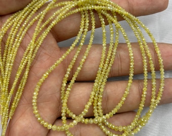 May include: Strands of small, yellow-toned beads, possibly gemstones, are displayed. The beads are strung together, creating multiple strands. The beads have a faceted appearance, catching the light. The overall color is a pale yellow, with a slight sparkle.