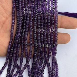 May include: A strand of purple amethyst beads, each bead is faceted and has a square shape. The beads are strung on a thin cord and are approximately 4mm in size.