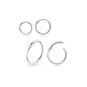 May include: Set of three silver hinged seamless rings for body piercing. The rings are different sizes and are shown on a white background.