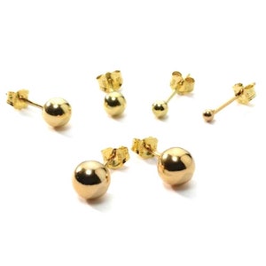 May include: A set of four gold ball stud earrings. The earrings are different sizes and are all made of 14k gold.