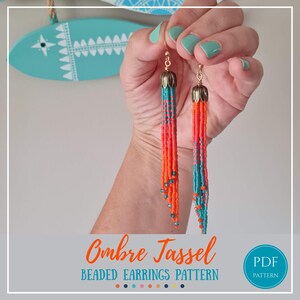 May include: Long fringe earrings featuring a gradient of seed beads transitioning from turquoise to bright orange. The earrings are topped with gold-toned metal caps and hang from hooks. The text Ombre Tassel BEADED EARRINGS PATTERN is visible.