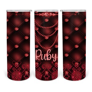 May include: Three red and black patterned tumblers with a diamond design and the name "Ruby" on the middle tumbler.