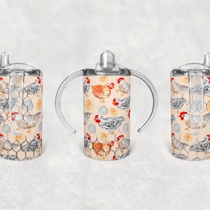 May include: Three clear plastic cups with handles and a straw lid. The cups are decorated with a pattern of chickens and eggs on a light beige background.