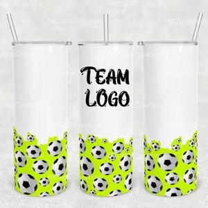 May include: Three white stainless steel tumblers with a green and white soccer ball design. The center tumbler has the text "TEAM LOGO" in black.