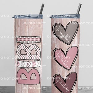 May include: Two stainless steel tumblers with lids and straws. The tumbler on the left has the word "Babe" written in pink and brown letters with a plaid pattern and hearts. The tumbler on the right has three hearts with the names "Payton", "Braden", and "Phillip" written inside.