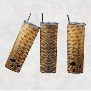 May include: Three stainless steel tumblers with a brown and gold patterned design. The pattern resembles fish scales.