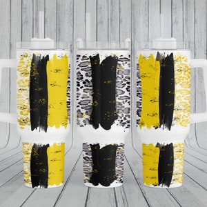 May include: Three stainless steel tumblers with a white handle and lid. The tumblers feature a black and yellow abstract design with a distressed look.