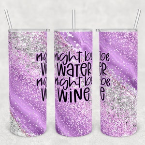 May include: Three stainless steel tumblers with a purple and silver glitter design. The tumblers have a white inscription that reads "Might be water might be wine".