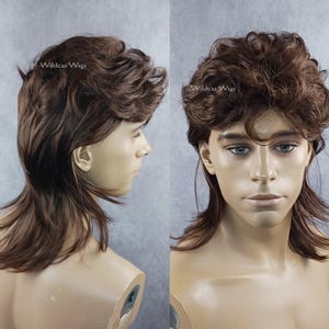 May include: A brown mullet wig with wavy hair. The wig has a short, layered top and longer, straight hair in the back. The wig is displayed on a mannequin head. The text "Wildcat Wigs" is visible.