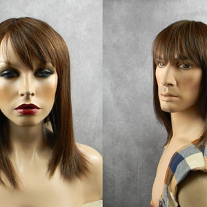 May include: A brown wig with long, straight hair and bangs. The wig is styled with a center part and the ends of the hair are slightly layered. The wig is shown on a mannequin head.