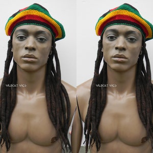May include: A mannequin wearing a black, green, yellow, and red crocheted beanie with long black dreadlocks. The mannequin is wearing a black shirt and has a tan complexion. The text "WILD CAT WIGS" is visible on the mannequin's chest.