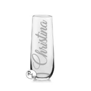 May include: A clear glass champagne flute with the name "Christina" etched on the side.