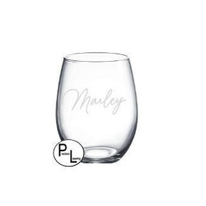 May include: Clear glass stemless wine glass with the name "Marley" etched on the side.