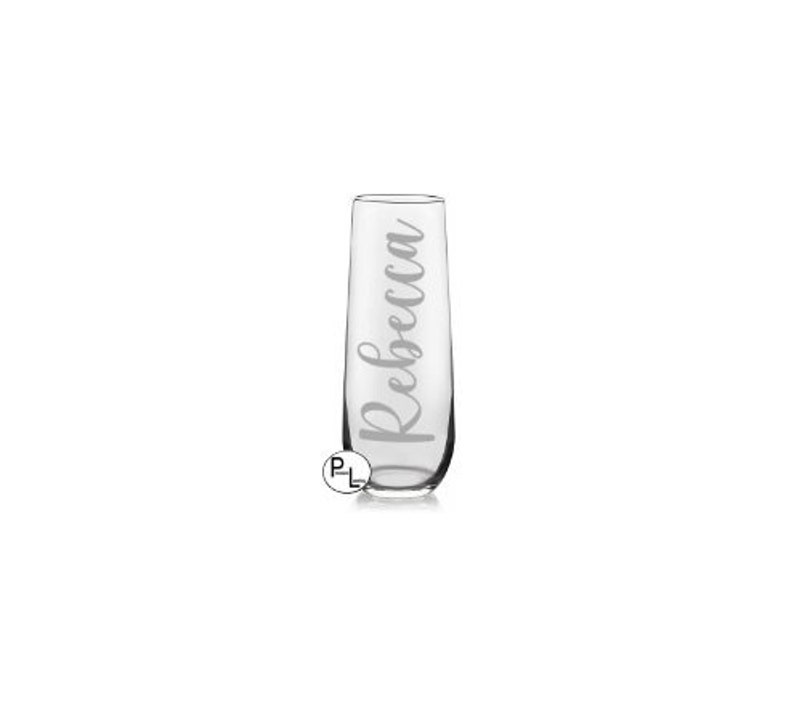May include: A clear glass champagne flute with the name "Rebecca" etched on the side.